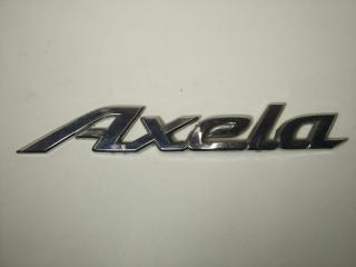 Запчасть эмблема багажника Mazda Axela